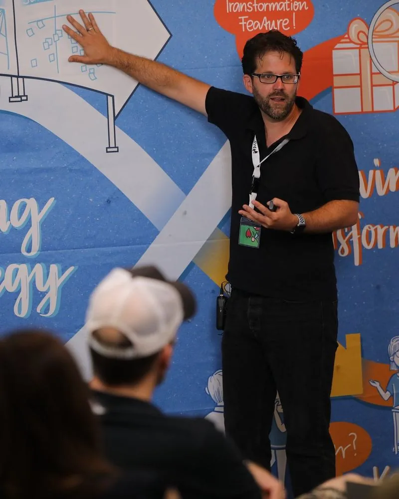Mario A. Brückner explaining the Living Strategy diagram to an audience during a keynote
